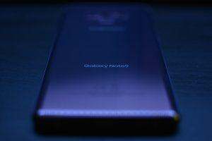 blue lenovo laptop computer on black table