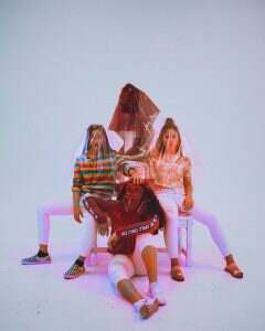 four person sitting on chair with plastic bag covering their heads