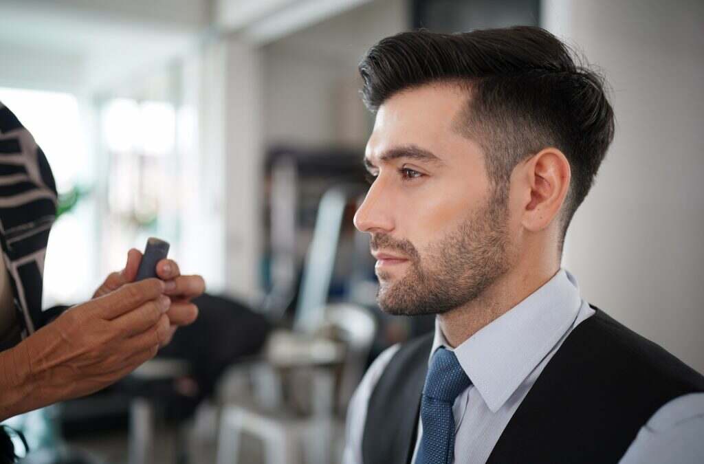 Professional actor preparation before shoot. Handsome young man applying by professional make up.