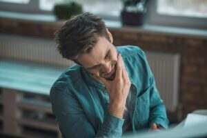 Sad unhappy man feeling very strong pain