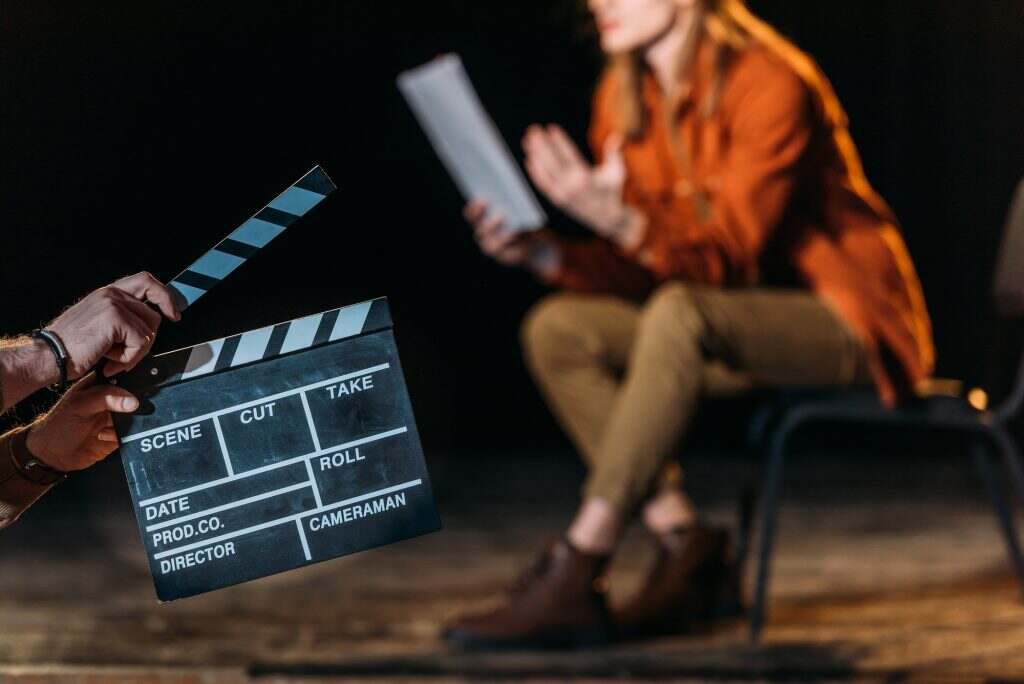 selective focus of actor with clapboard in front
