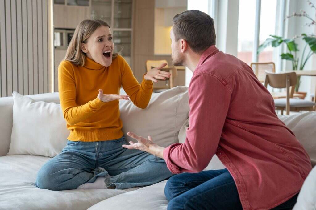 Reproachful wife shouting at delinquent husband. Misunderstanding and disagreement in family life