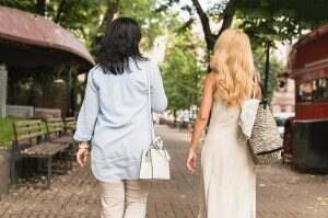 Two caucasian mature best friends girlfriends sisters women walking