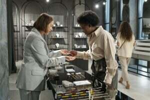 Young African consumer choosing bracelet in jewelry shop