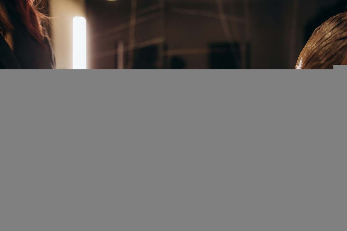 Hair coloring in the salon, hair styling. Professional wizard paints the hair in the salon.