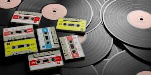 Vintage audio cassettes on wooden background, mix tape label, 3d illustration
