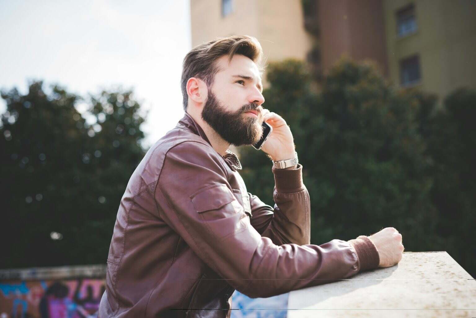 Young bearded man using smartphone