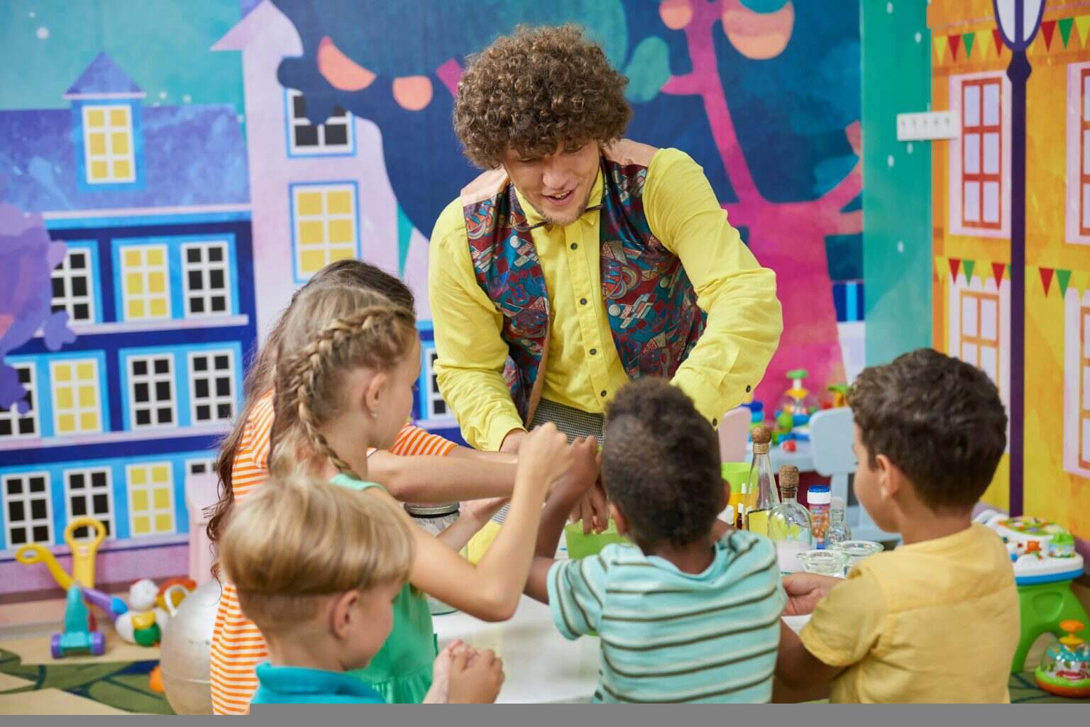 Animator with happy children indoor.