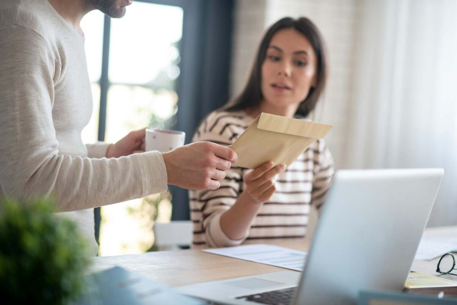 Close up of wife giving letter to husband after going to post