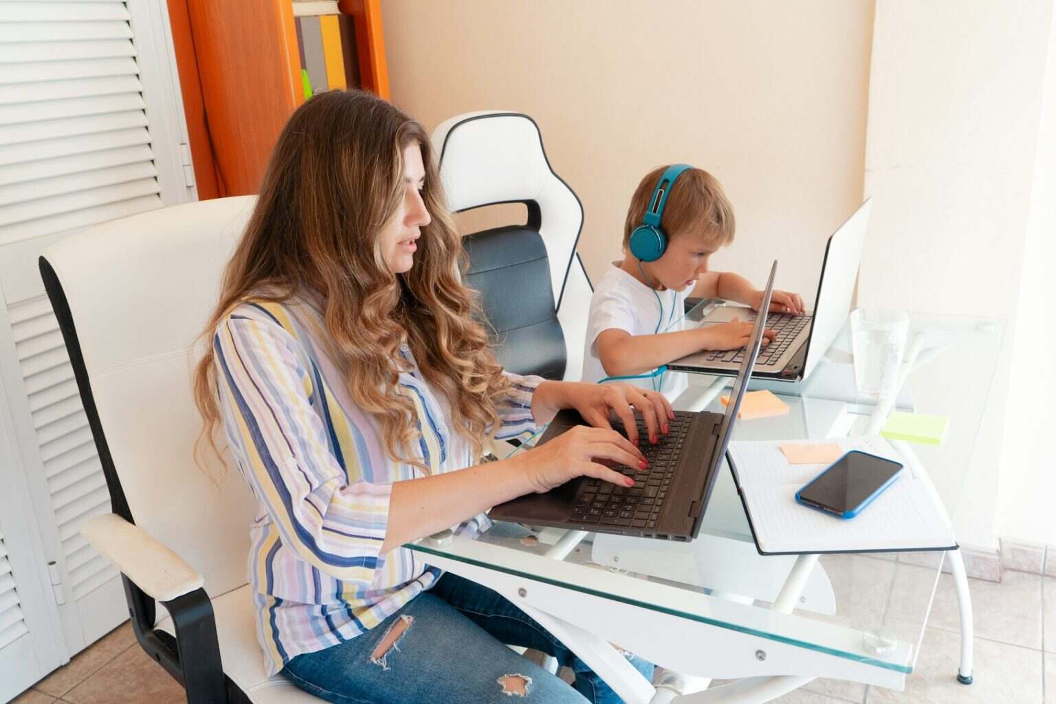 Mother working home with son