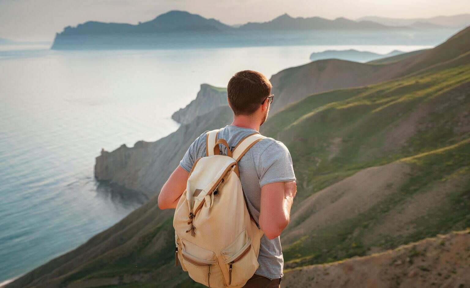 Young man travels alone on the backdrop of the mountains