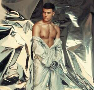 Fashion, sci fi and silver with a trendy man at a photo shoot in a shiny outfit for futuristic styl
