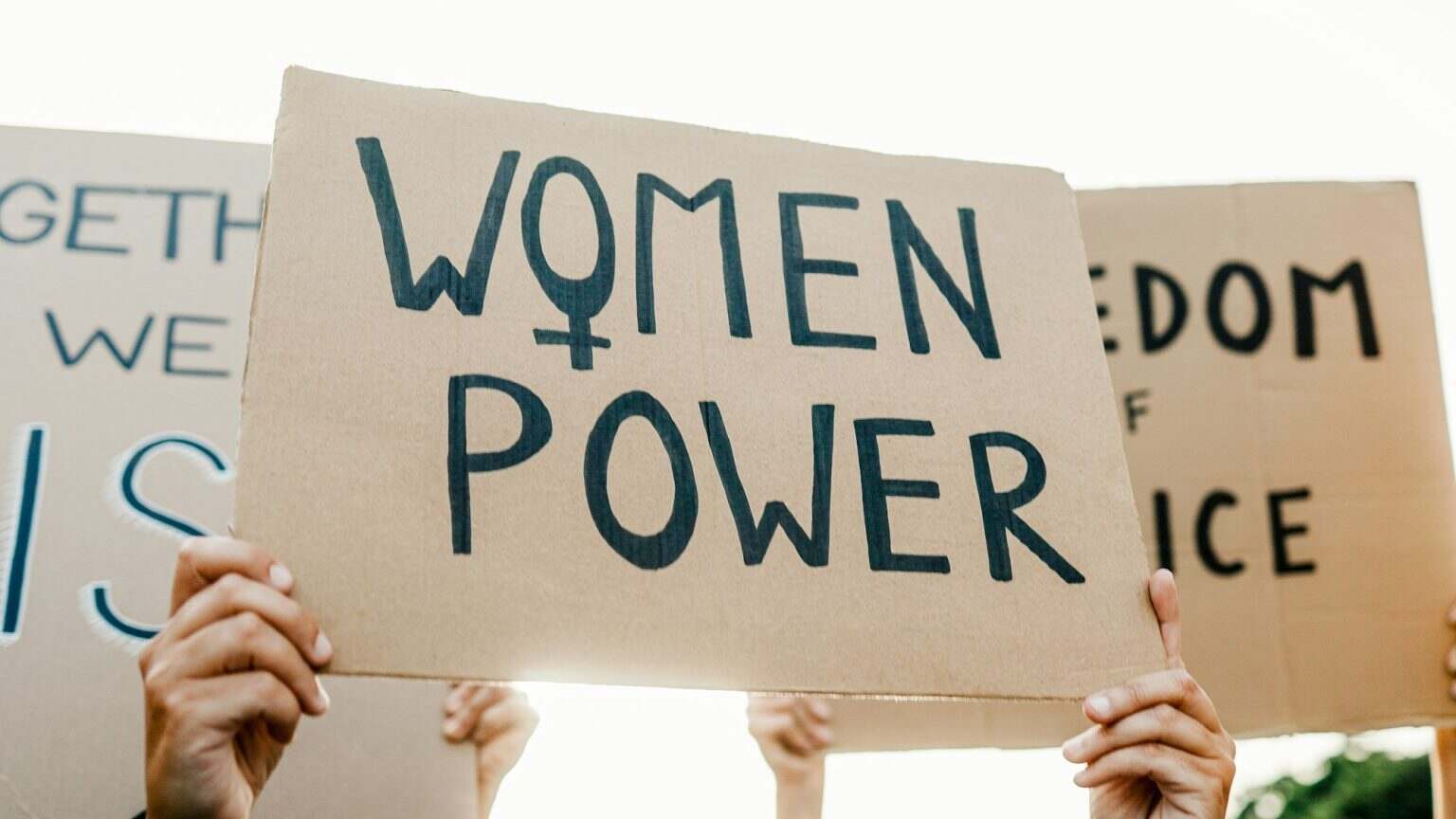 Group of women protest for female rights at demonstration. Feminist empowerment and equality