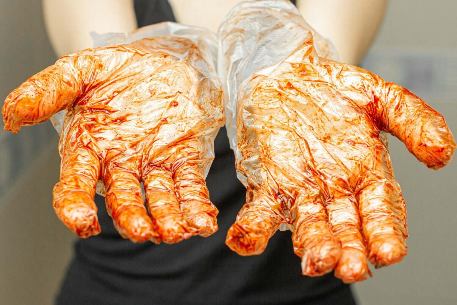 Hands in gloves stain with dye