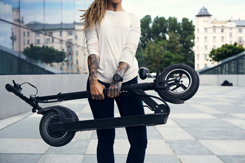 Portrait of attractive girl with electro scooter