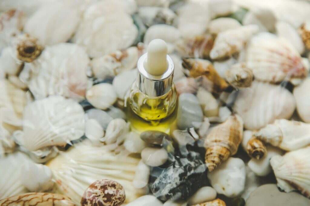 Bottle with cosmetics on the seabed. Selective focus.