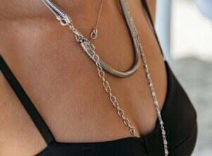 Close-up of woman wearing black dress and silver jewelry.
