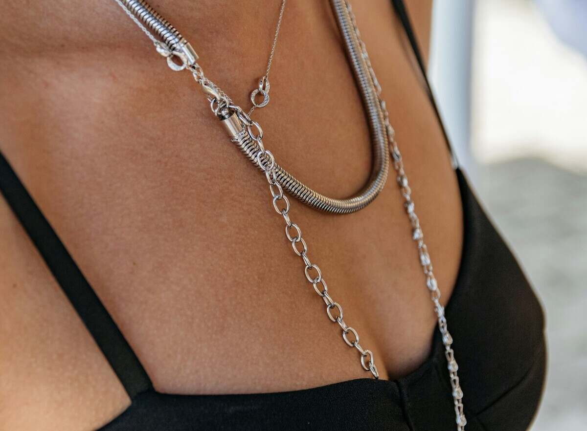 Close-up of woman wearing black dress and silver jewelry.