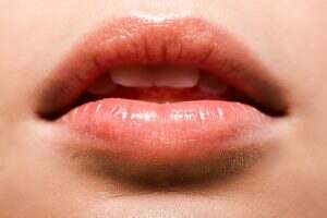 close up of woman with shiny lip gloss on lips