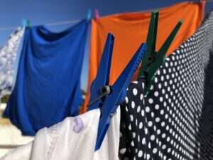Clothes hanging out to dry on washing line outdoors in the sun.