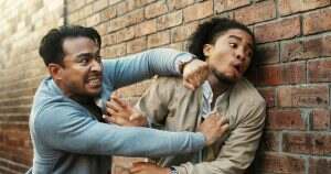 Crime, fighting or threat with men in city for aggressive disagreement, physical harm and violence.