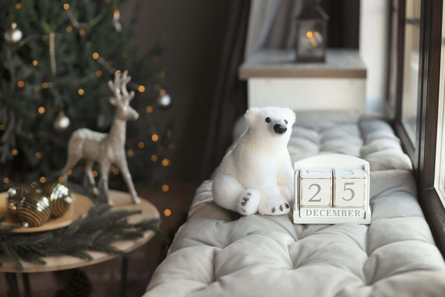 Decorated home room with interior calendar date December 25 and christmas tree with light garland