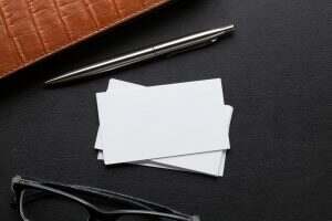 Office desk with business cards and supplies