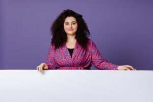 Plus size woman in bright suit