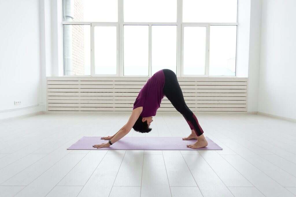Yoga, people concept - a middle-aged woman doing a yoga and try to do a asana