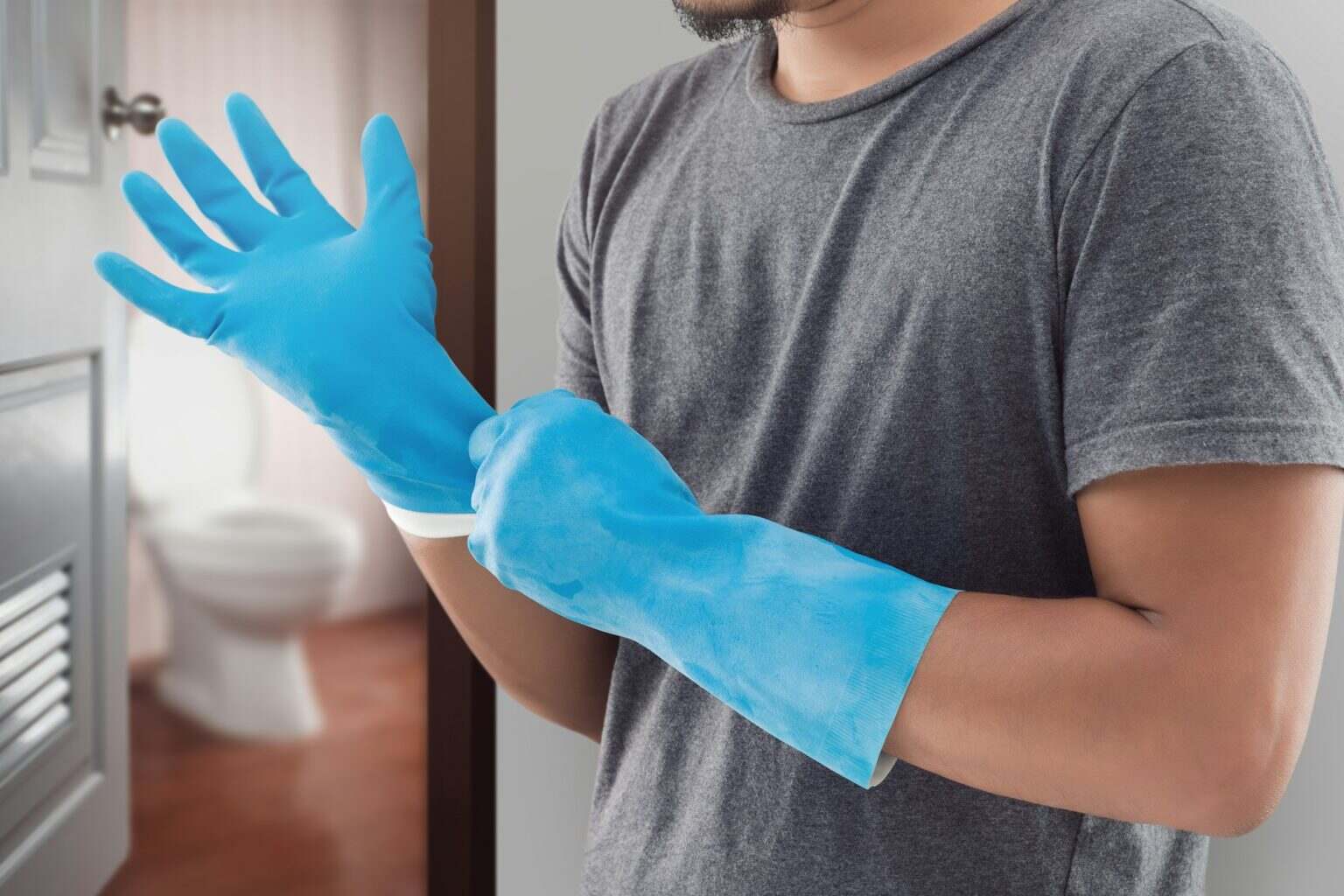 Asian man is preparing all equipments for cleaning toilet.