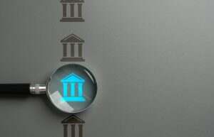 Bank research. Magnifying glass and a bank. Interest rates, investment opportunities