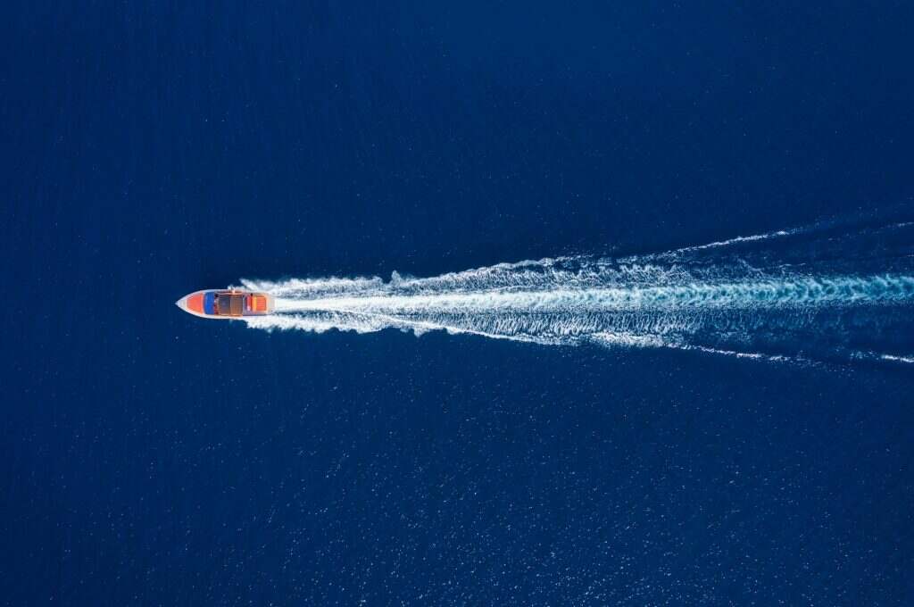 Fast boat at the sea in Bali, Indonesia. Aerial view of luxury floating boat