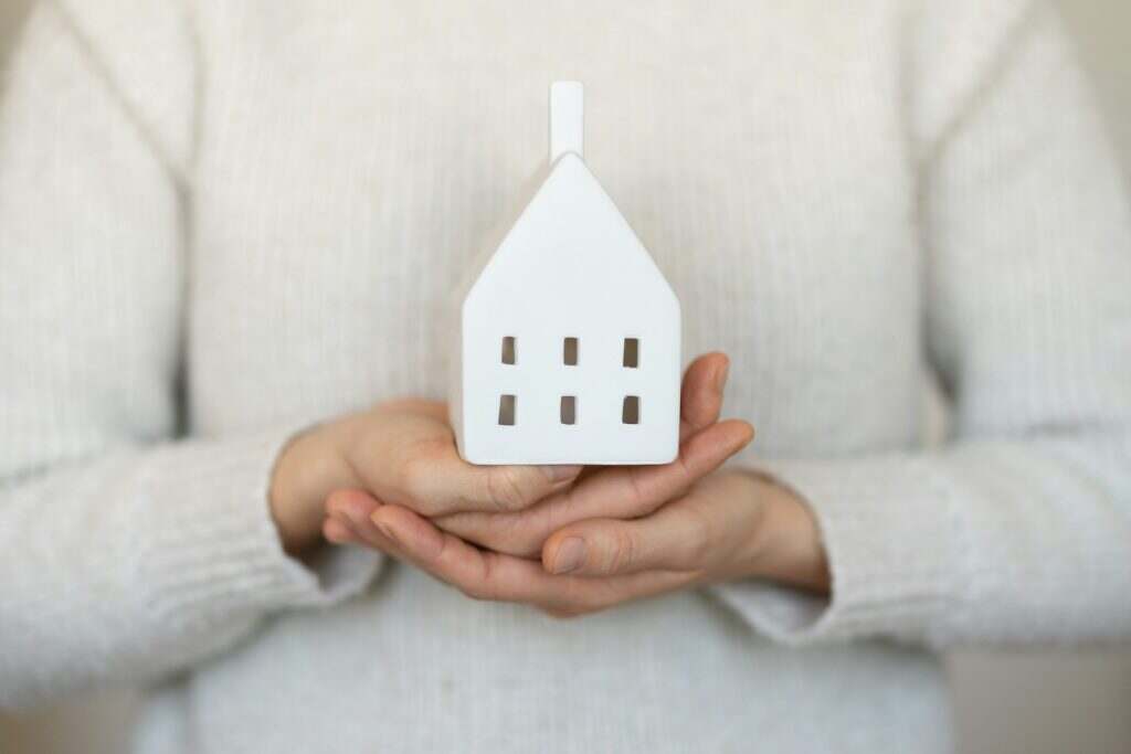 Holding the model house, real estate insurance and banking concept