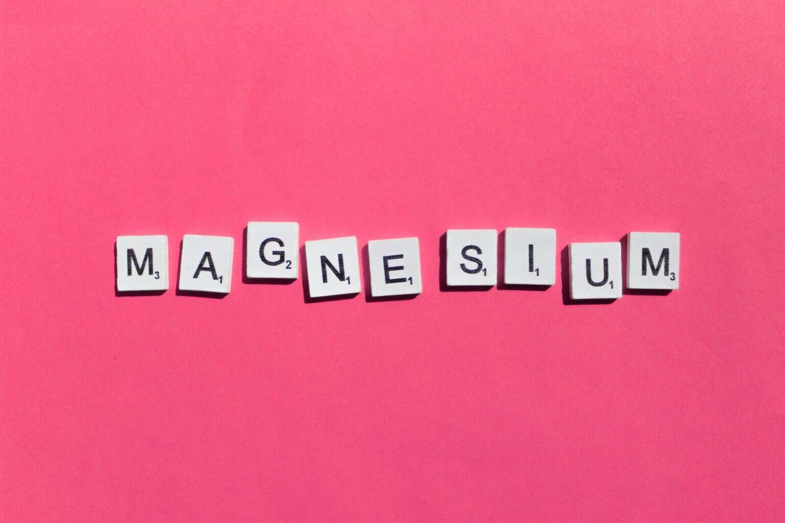 Magnesium scrabble letters word on a pink background