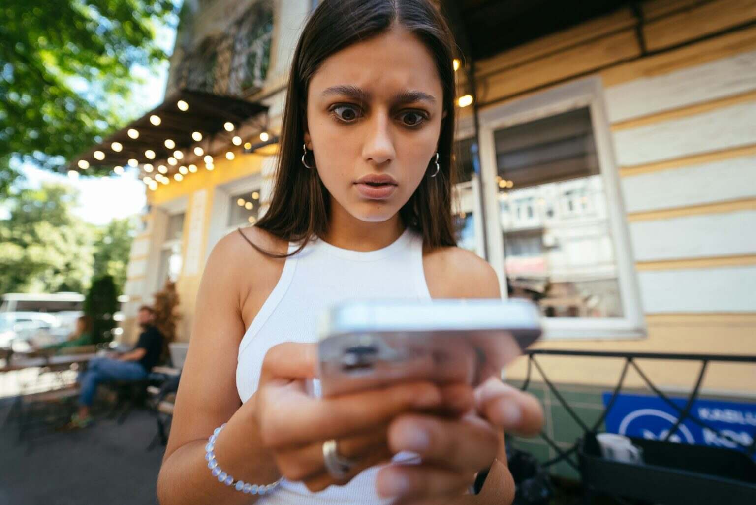 Pretty woman an urban street to read an sms on her mobile phone