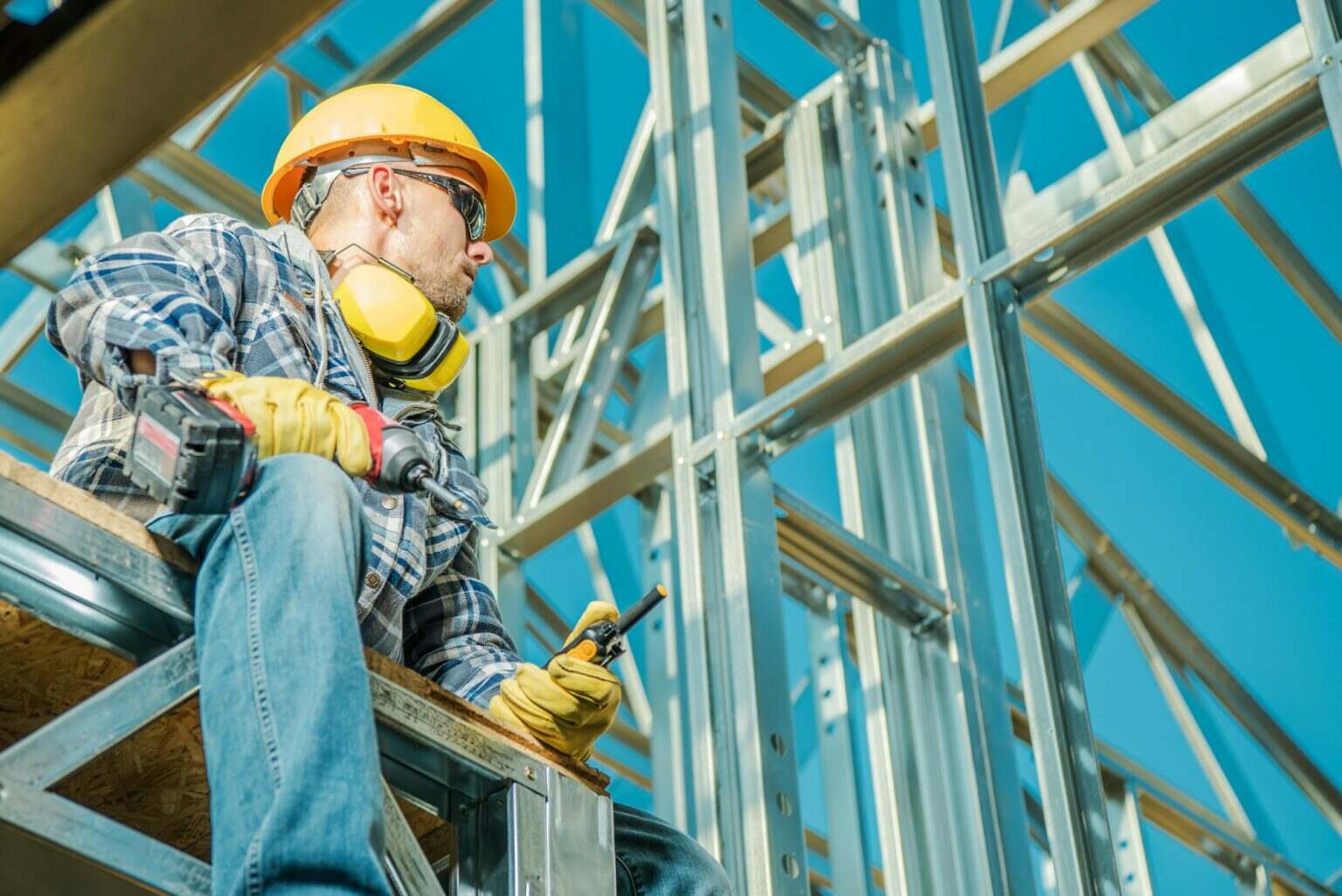 Professional Building Contractor in Front of Skeleton Frame