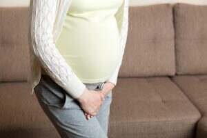 close up of pregnant women urine urgency at home. pregnant urinary incontinence concept