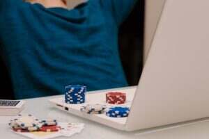 Unrecognizable gamer man playing with his laptop from home to casino games