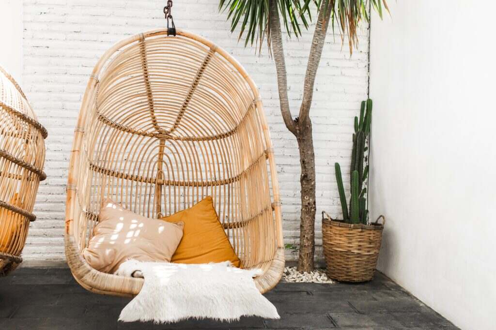 Wicker rattan hanging chair in loft cafe. Eco friendly furniture style and concept