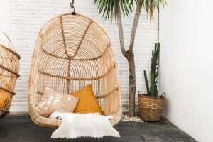 Wicker rattan hanging chair in loft cafe. Eco friendly furniture style and concept