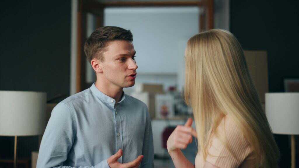 Angry couple discussing disagreement in unhappy relationship at home close up.
