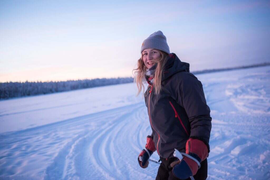 Skiing on the frozen lake at Torassieppi at sunset, Lapland, Finland