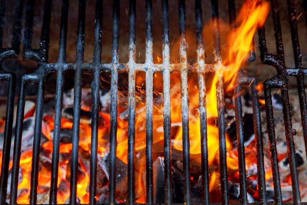 Top View Of Empty And Clean Barbecue Charcoal Grill With Flames Of Fire, Close Up