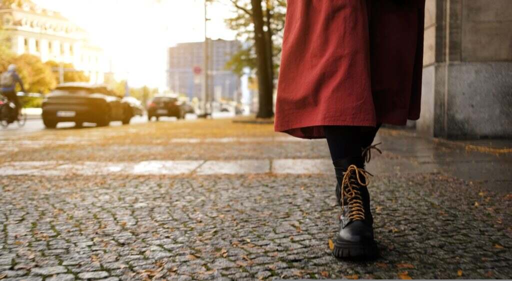 Woman In Long Red Skirt And Black Boots