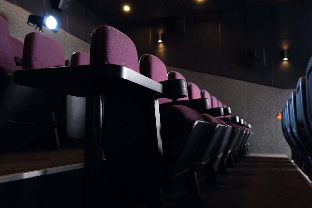 red seats in empty dark movie theater