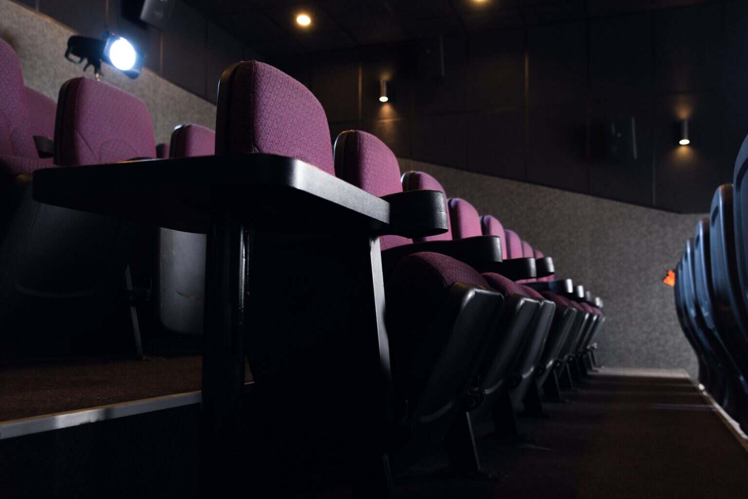 red seats in empty dark movie theater