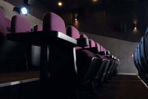 red seats in empty dark movie theater