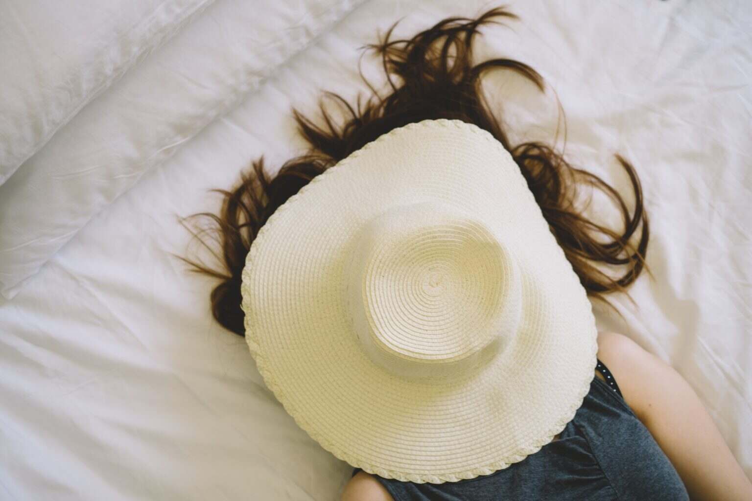 Sleeping woman with a hat covered