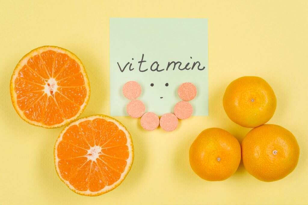 Sticker with the word vitamin C. Background yellow, vitamin C, citrus
