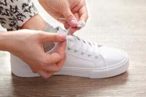 Woman tying shoelaces